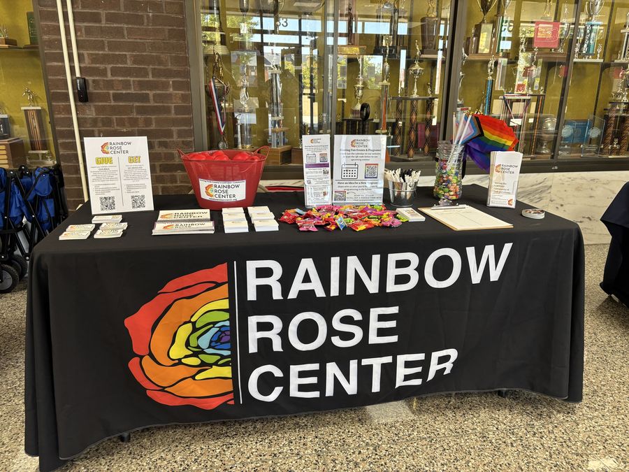 Rainbow Rose Center outreach table with information and giveaways at a community event